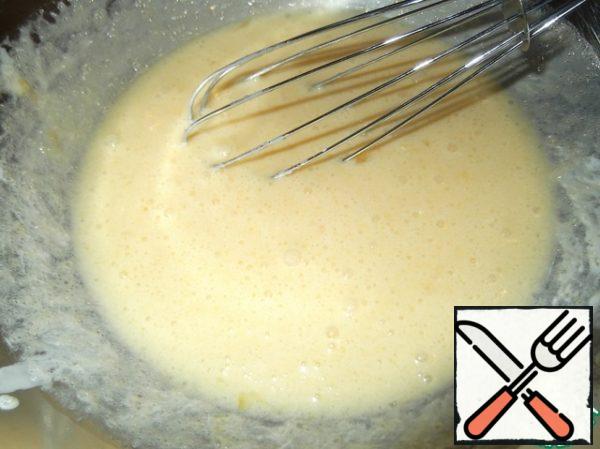 Warm melted butter is mixed with sugar. After that, add the eggs and mix too.