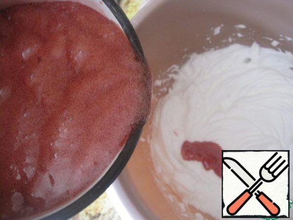 Pour the hot syrup into the proteins continuing to whisk, while the mass becomes white with a creamy pink tint.