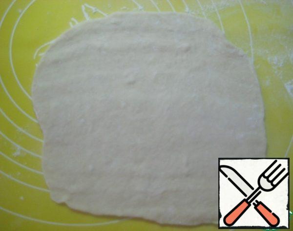 Roll out a piece of dough into a rectangle.