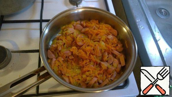 To amazingly smelling oil with Golden onions add grated carrots and smoked meat.