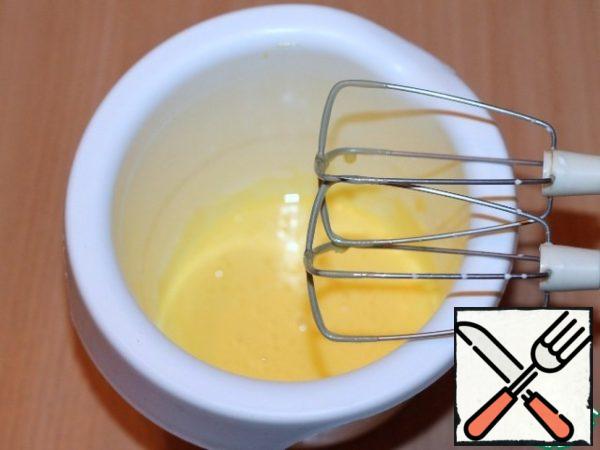 Beat the egg yolks with a mixer until white.