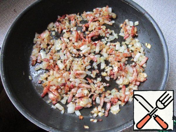 Put a pot of water on the fire. Fry diced bacon and onion. This will take 10 minutes.