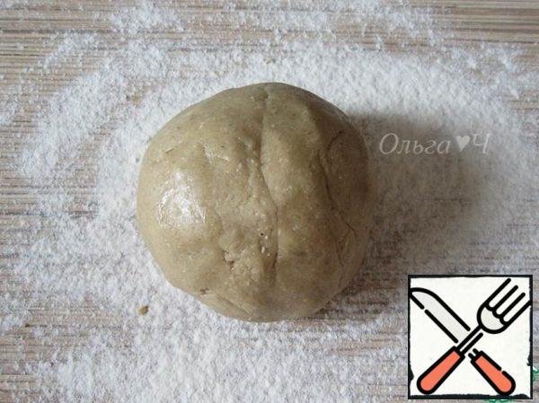 Shift the mass to the work surface and knead the dough with your hands.