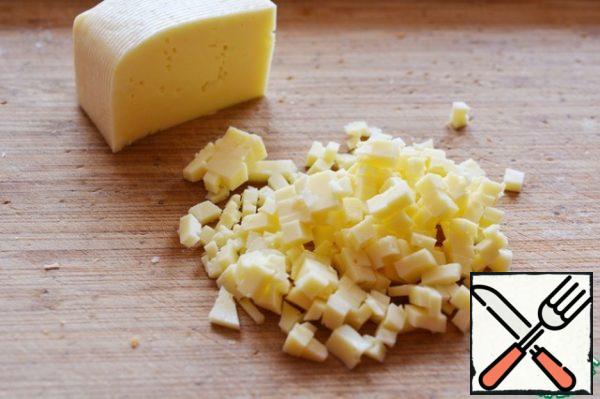 Cut the cheese into small cubes.