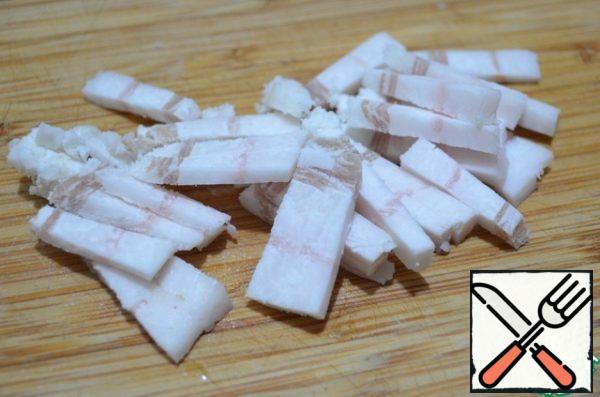 The salty lard cut into thin slices.
