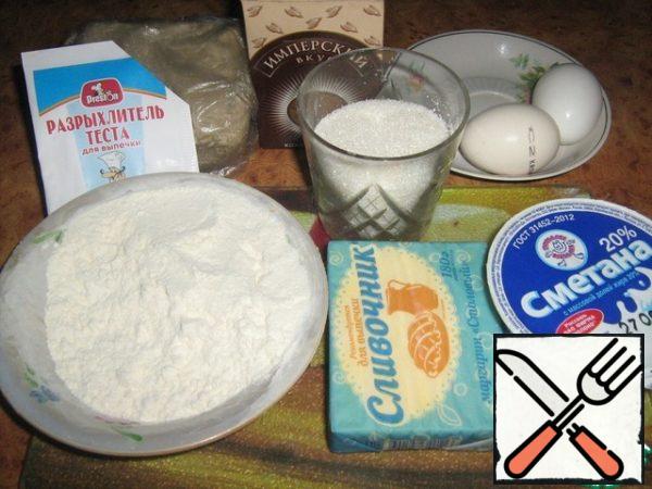 Prepare the ingredients for the dough: eggs,sugar, margarine, melt, sour cream, flour, cocoa powder, baking powder, grated halva.