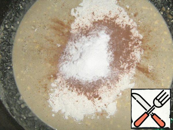 Sifted flour with sifted cocoa powder and baking powder to connect. Pour the halva mixture.