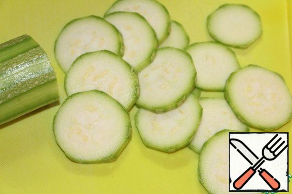 While the dough is resting in the cool, let's do the filling. Cut the courgettes into thin slices.