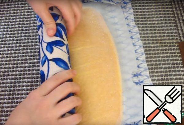 Remove the biscuit from the oven and immediately wrap in a damp towel. Let cool.