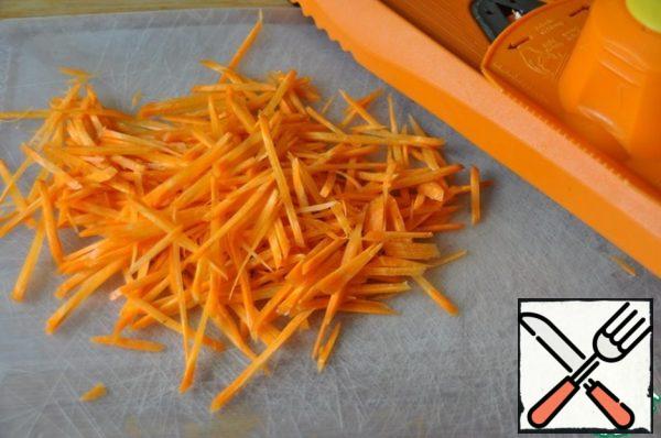 Take a carrot and grate into thin strips.