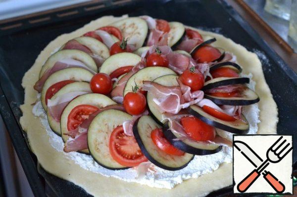 Spread in a circle, and fill the middle.
Spread the cherry tomatoes.
Salt and pepper. On top drizzle with olive oil.