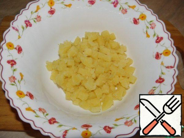 Boil potatoes, cut into cubes.
