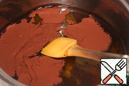 In a saucepan with a thick bottom, mix butter, water, zest and sugar. Stirring constantly, heat, not bringing to a boil, but to complete dissolution of sugar.
Add the cocoa sifted through a sieve, bring to a boil and immediately remove from heat.