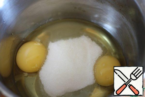 Beat eggs with sugar until white.