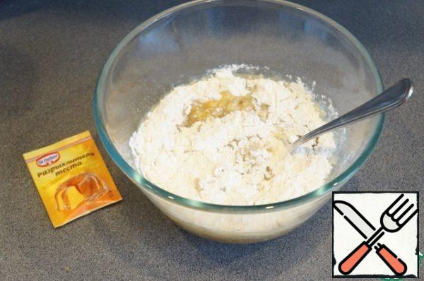 Add chopped nuts and raisins soaked in hot water (drain). Add both types of flour, baking powder.