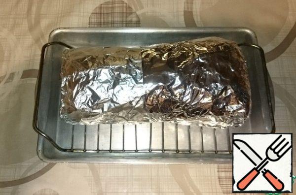 Tightly wrap the meat in foil and put in a preheated 180 C oven for 2 hours.