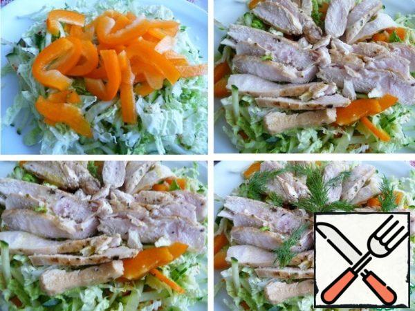 Add chopped bell pepper and mix.
Cut chicken meat into ribbons or pick.
Put on top of the salad. Season with olive oil and add freshly ground black pepper.
Garnish with greens.
Salt before serving.