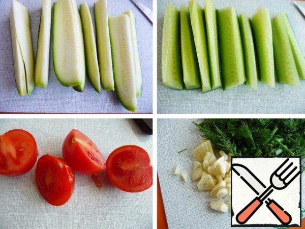 Zucchini and cucumber cut into strips.
Cut the tomato into halves.
Chop the garlic and dill.
