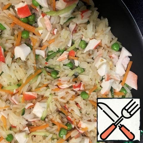 Add 3 tbsp of soy sauce to the rice, add crab sticks and mix gently.