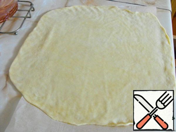 Then roll it into a layer larger in diameter than the pie should be, and shift to a baking sheet.