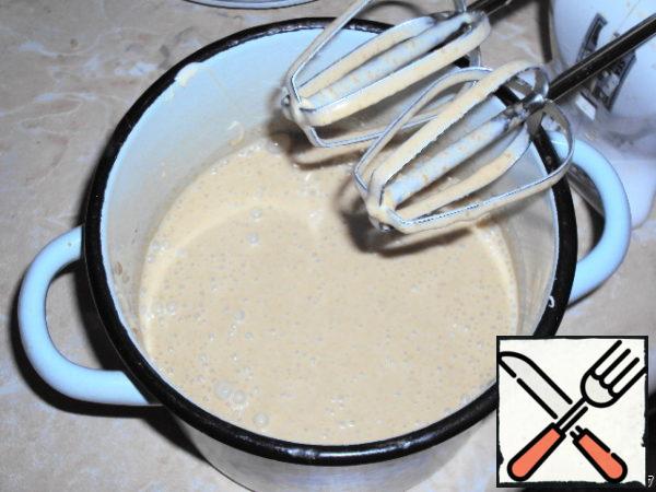 Pour the cooled coffee-yolk mixture into the whipped cream and beat lightly again until smooth.
