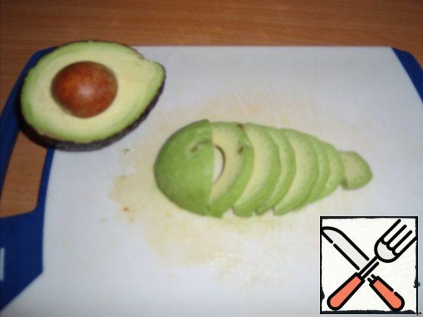Also cut the avocado, each half across.
