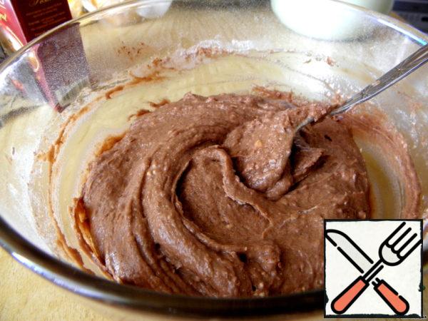 Pour in the flour + cocoa and gently, with a spoon, knead the soft dough.
