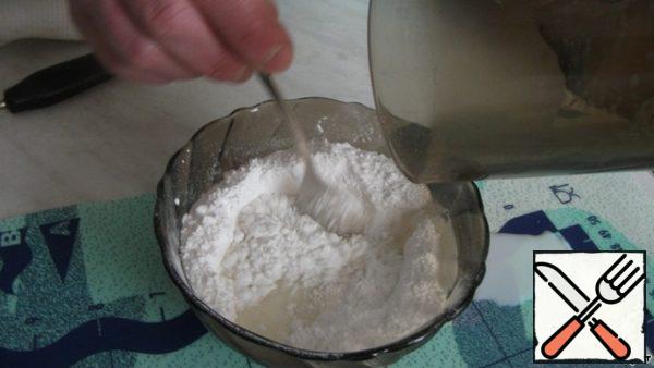Heat in a microwave in a glass of 2 tablespoons of milk and pour, stirring, into the powdered sugar.