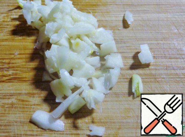 Garlic crush the flat side of a knife then finely chop.