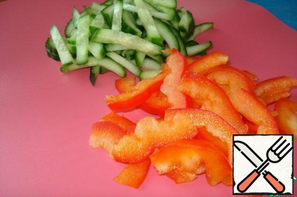 Cucumbers and bell peppers cut into strips.
