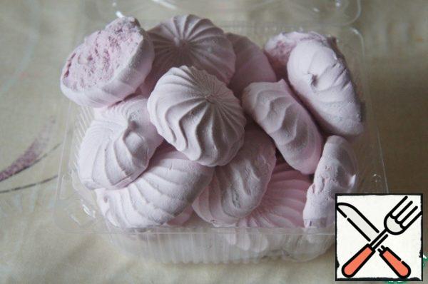 While the cookies are baking, divide the marshmallows into halves.
