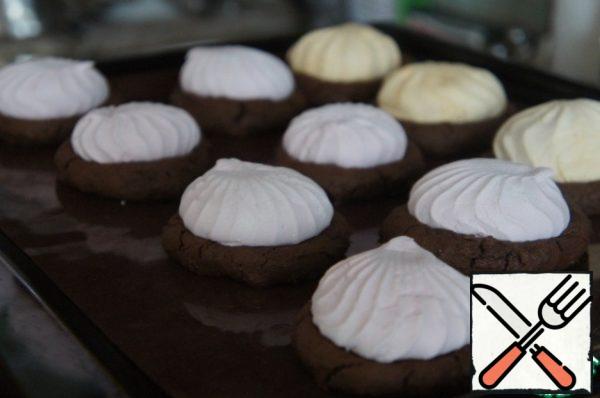 Remove the baking sheets from the oven and place half of the marshmallows in the center of each cookie, slightly pressing down.
