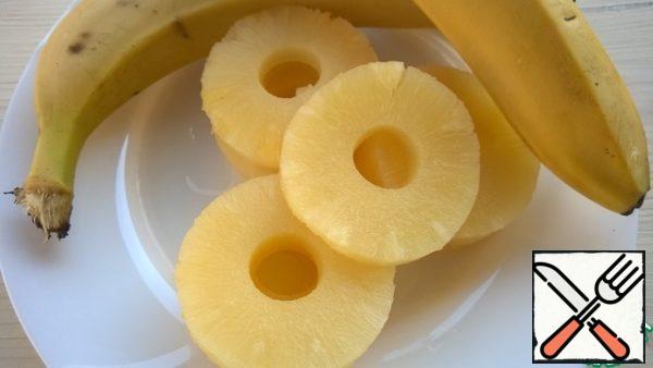 Cut bananas and sprinkle with lemon juice, so they do not darken. Pineapples cut into pieces.