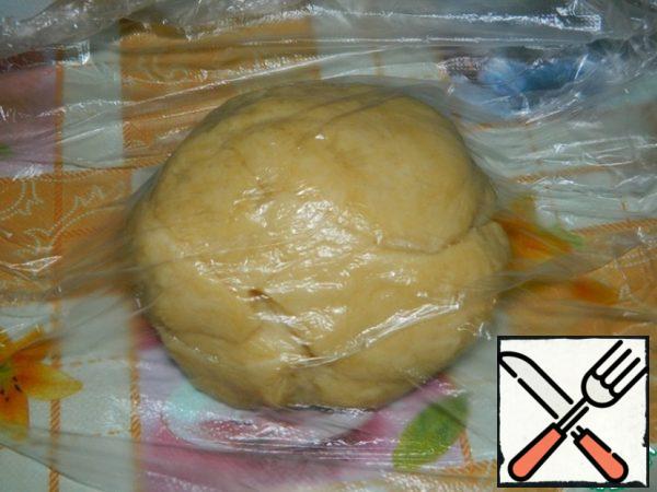 Cover the dough with a film and leave on the table for 30 minutes to rest.