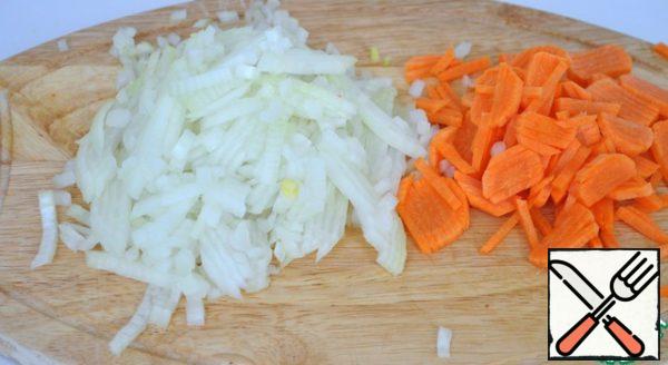 Cut onions and carrots.