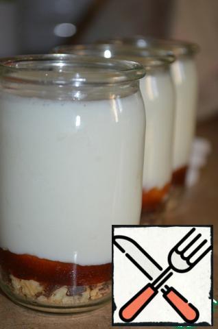 Milk-yogurt mixture is poured into jars.