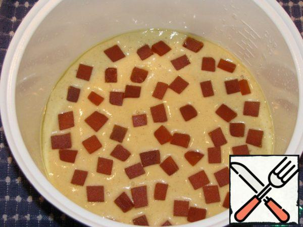 Marmalade cut into cubes. The dough is poured into a baking dish, spread on top of the cut marmalade. Since the dough is not thick, the marmalade itself will go into the dough, it is not necessary to mix.