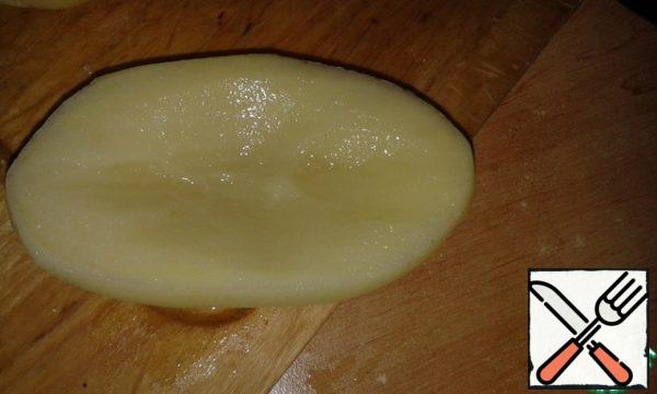 Peel potatoes, cut lengthwise and cut out the middle.