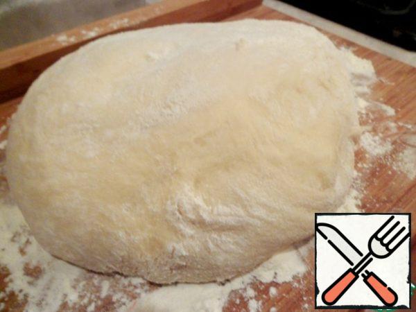 Remove the dough from the bread maker and divide into 2 parts.
