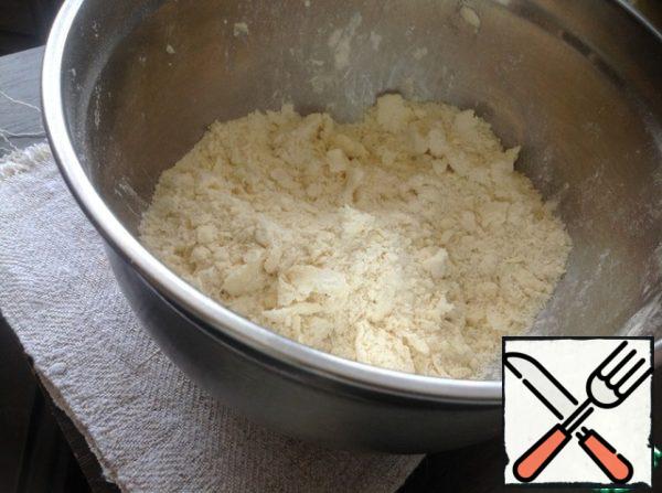 Grind the cooled butter with the sifted flour into crumbs.