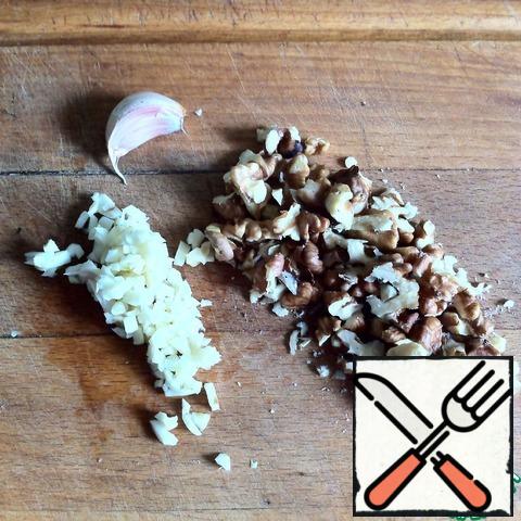 Garlic very finely chop the nuts coarsely chop.