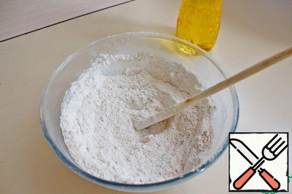 In a bowl, mix both types of flour, salt, baking powder.
