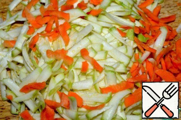Wash zucchini and carrots, peel and grate.
