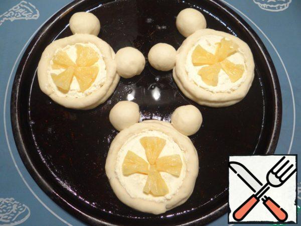 Then I decorate the cheesecakes with pineapple slices (you can cut them into small cubes), just press them into the curd mass.