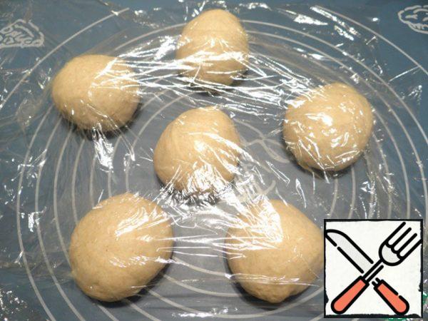 Cover the balls of dough with film.