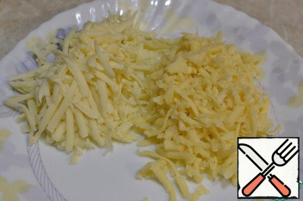 RUB two types of cheese on a coarse grater