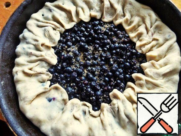 Pull the edges of the dough on the berries and pinch chaotically.