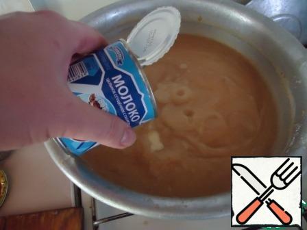 Pour in the condensed milk, which includes only whole milk and sugar.