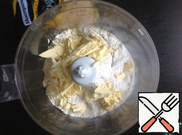 Pour flour, powdered sugar, salt and sliced frozen margarine into the blender bowl.