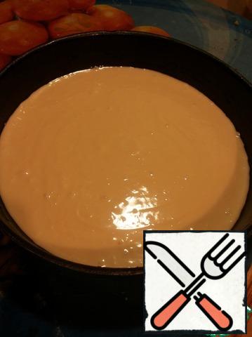 Add sour cream, soda, salt, condensed milk and whisk. Then add the flour with baking powder. Beat for three minutes and pour into a greased sunflower oil form (diameter 25 cm).